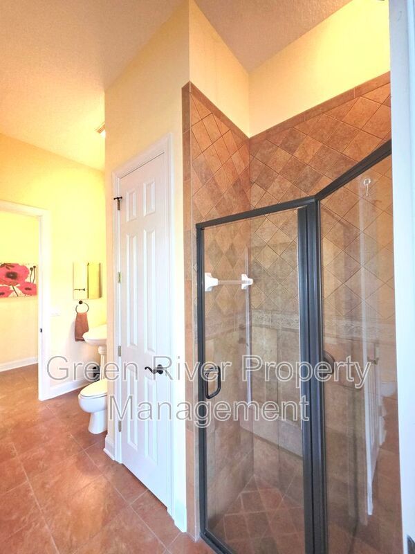 Spacious 5BR/5BA Home with Screened Pool & Pond View in Eagle Harbor at Black Creek! property image