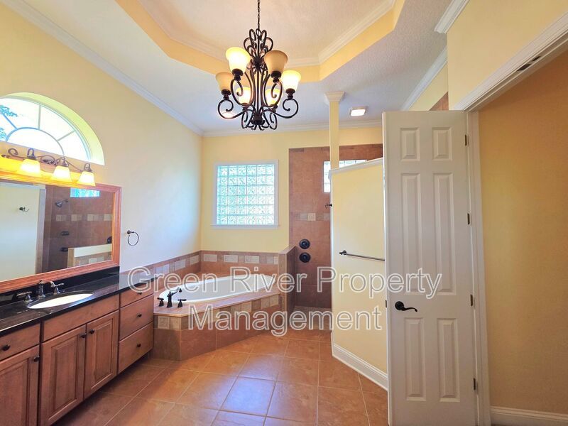 Spacious 5BR/5BA Home with Screened Pool & Pond View in Eagle Harbor at Black Creek! property image