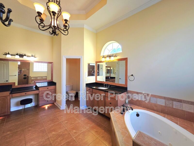 Spacious 5BR/5BA Home with Screened Pool & Pond View in Eagle Harbor at Black Creek! property image